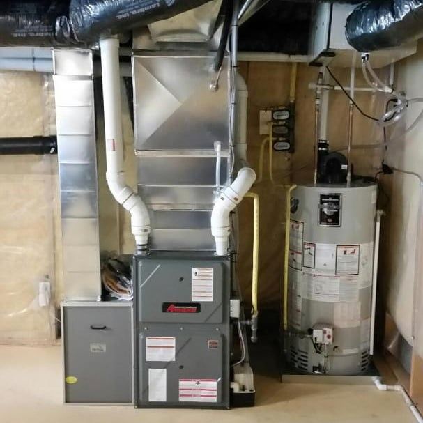 Amana high-efficiency furnace with tank water heater in basement