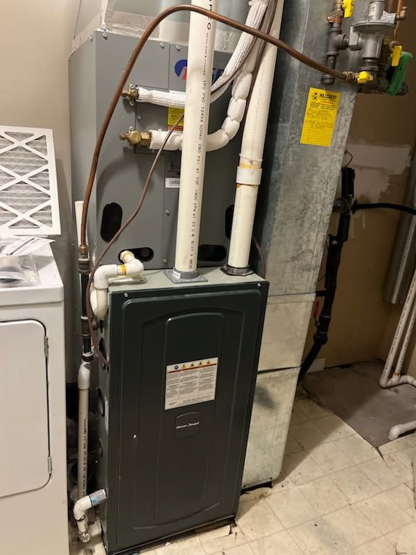 American Standard high-efficiency furnace in basement utility area