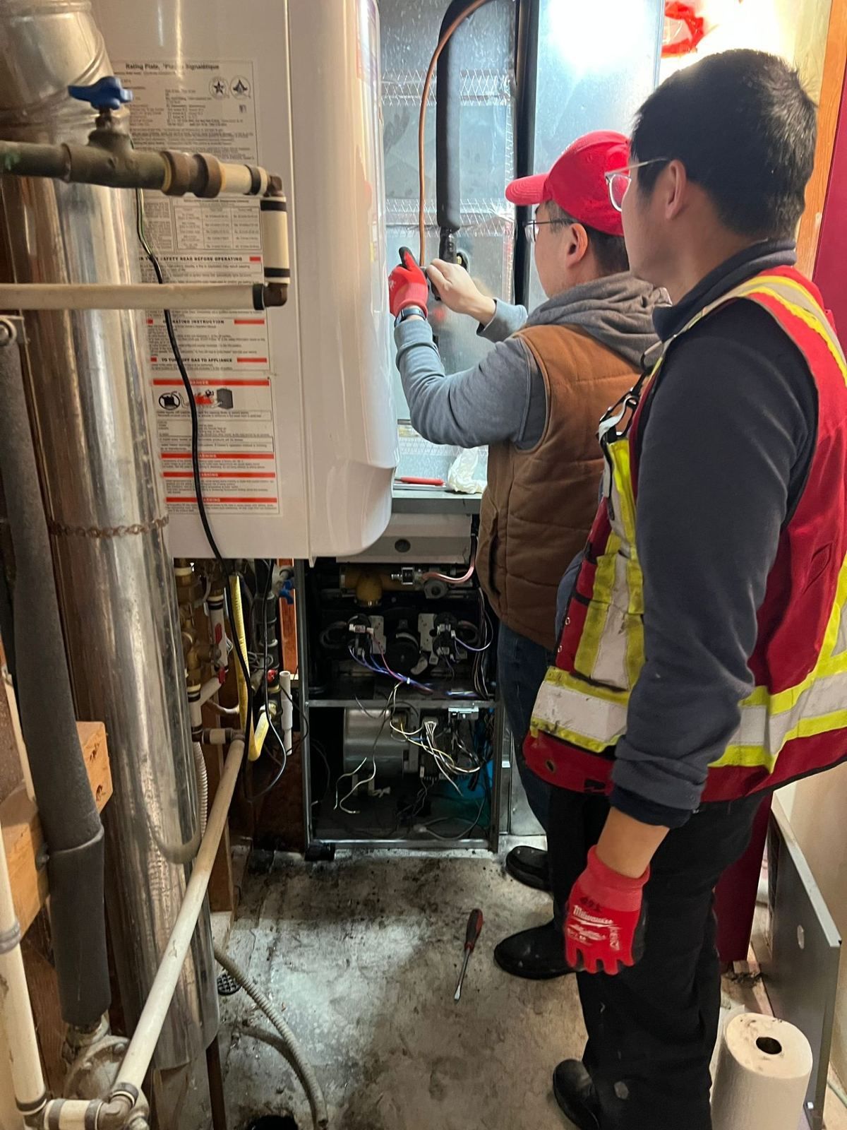 Team inspecting old gas furnace before removal
