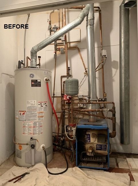Old cast-iron boiler and GE hot water tank before replacement
