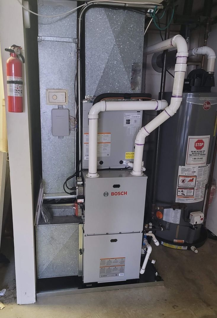 Bosch high-efficiency furnace installed next to Rheem water heater