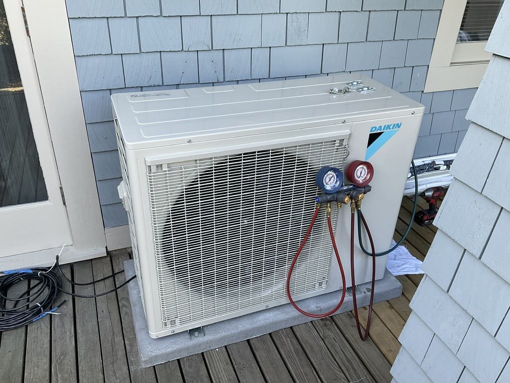 Daikin ductless mini-split outdoor unit with manifold gauges during vacuum and pressure testing — 360 Install Solution BC