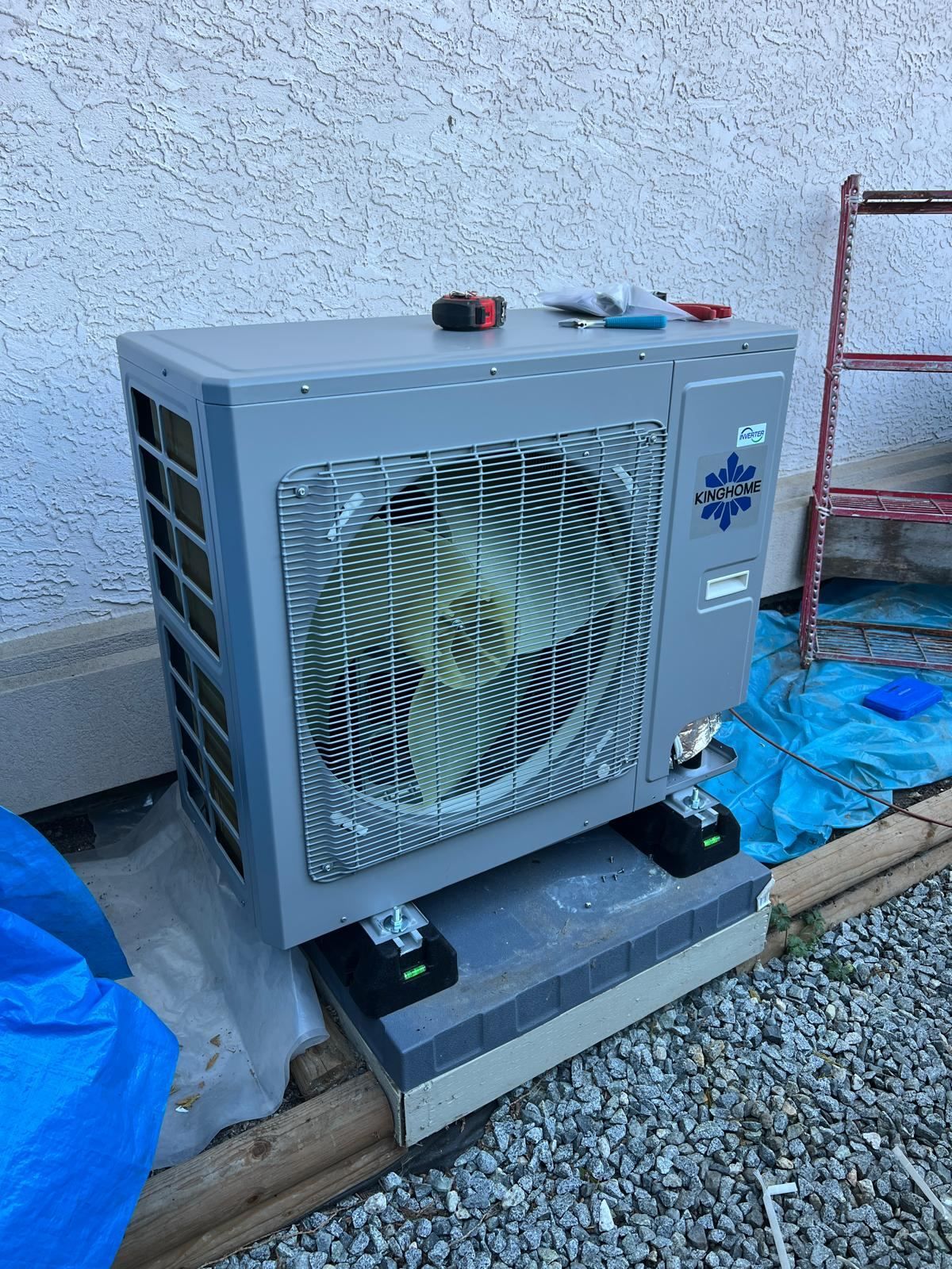 KingHome outdoor heat pump condenser mounted on concrete pad