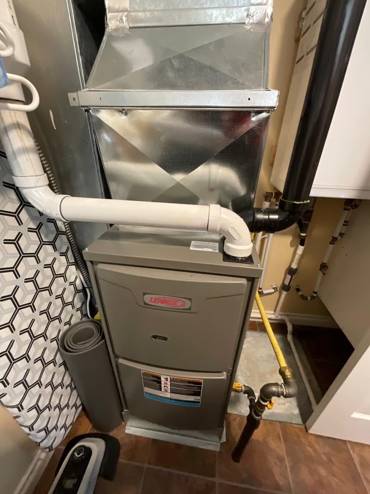 Lennox high-efficiency furnace installed in closet space with ductwork