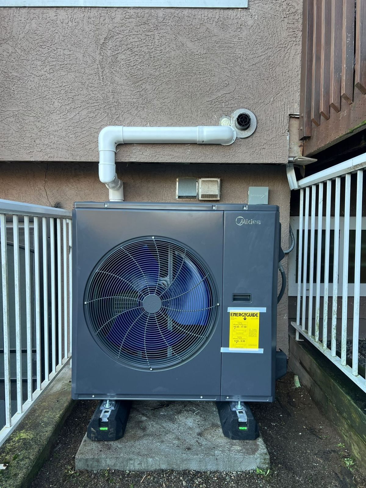 Midea outdoor heat pump condenser installed at a Metro Vancouver home — 360 Install Solution