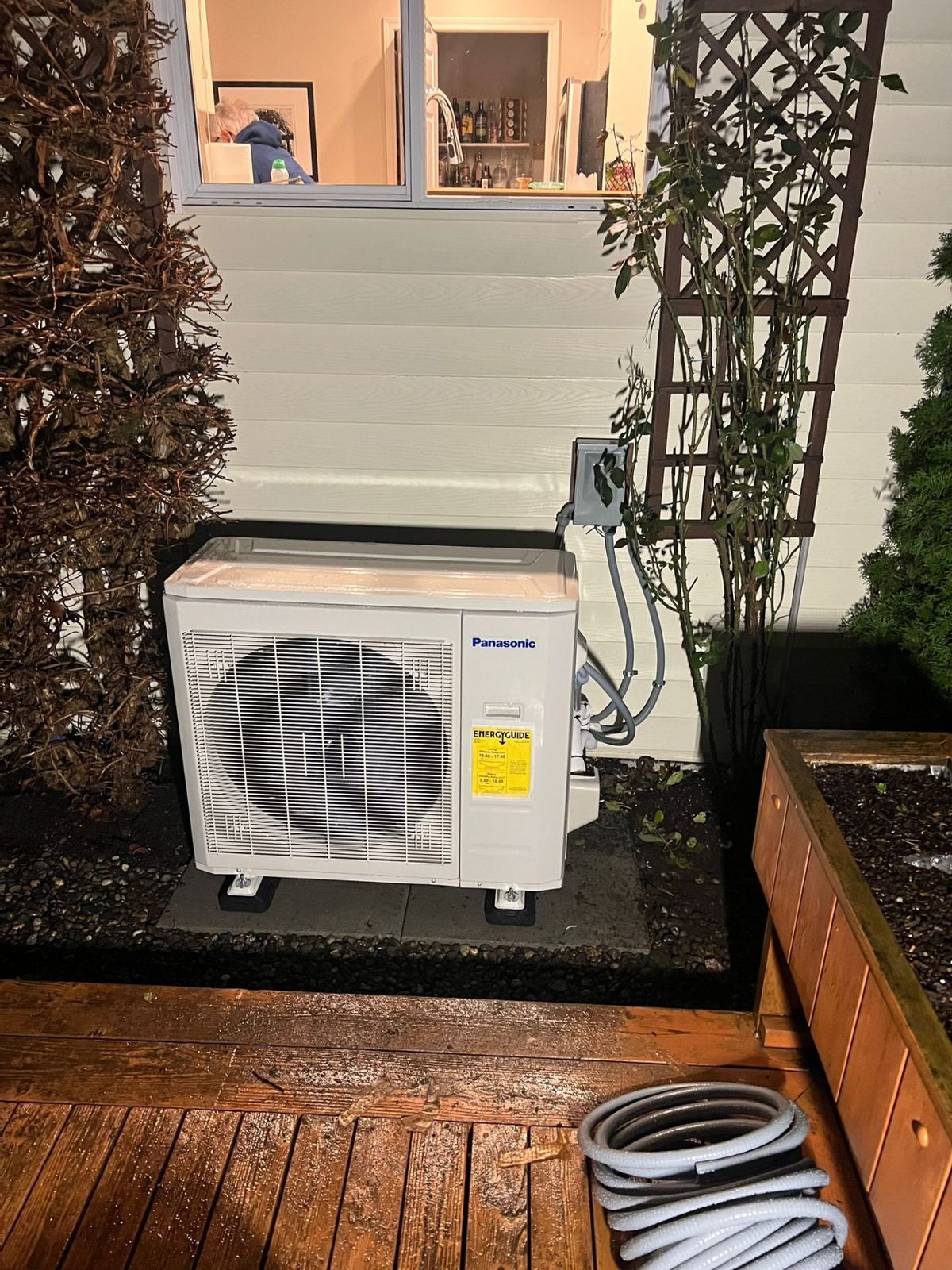 Panasonic outdoor heat pump condenser with EnergyGuide label