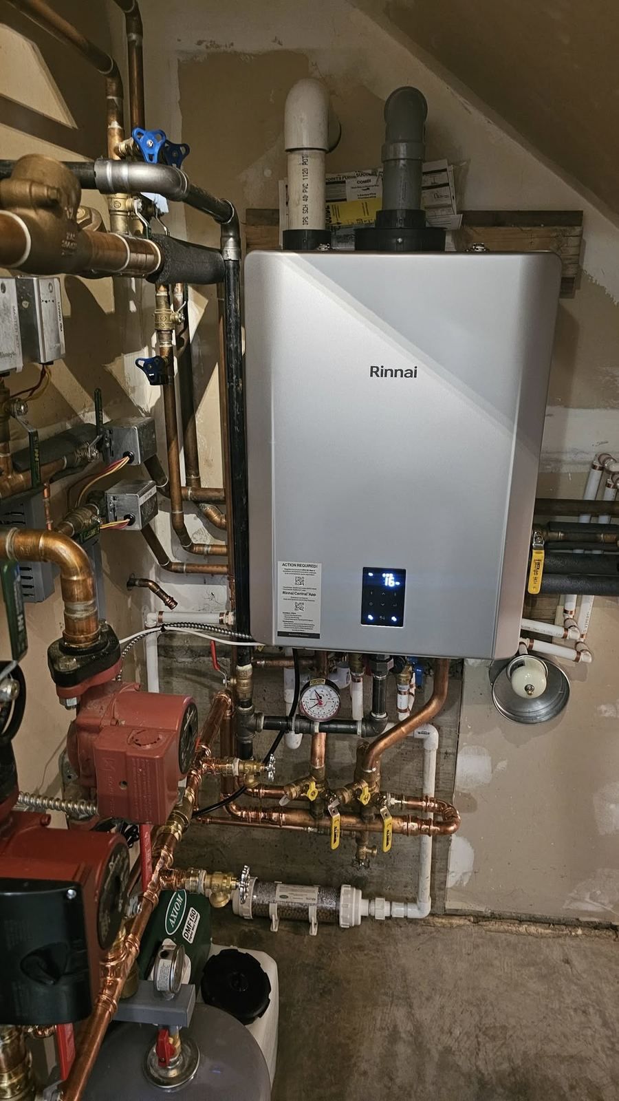 Rinnai boiler installed under stairs with PVC venting