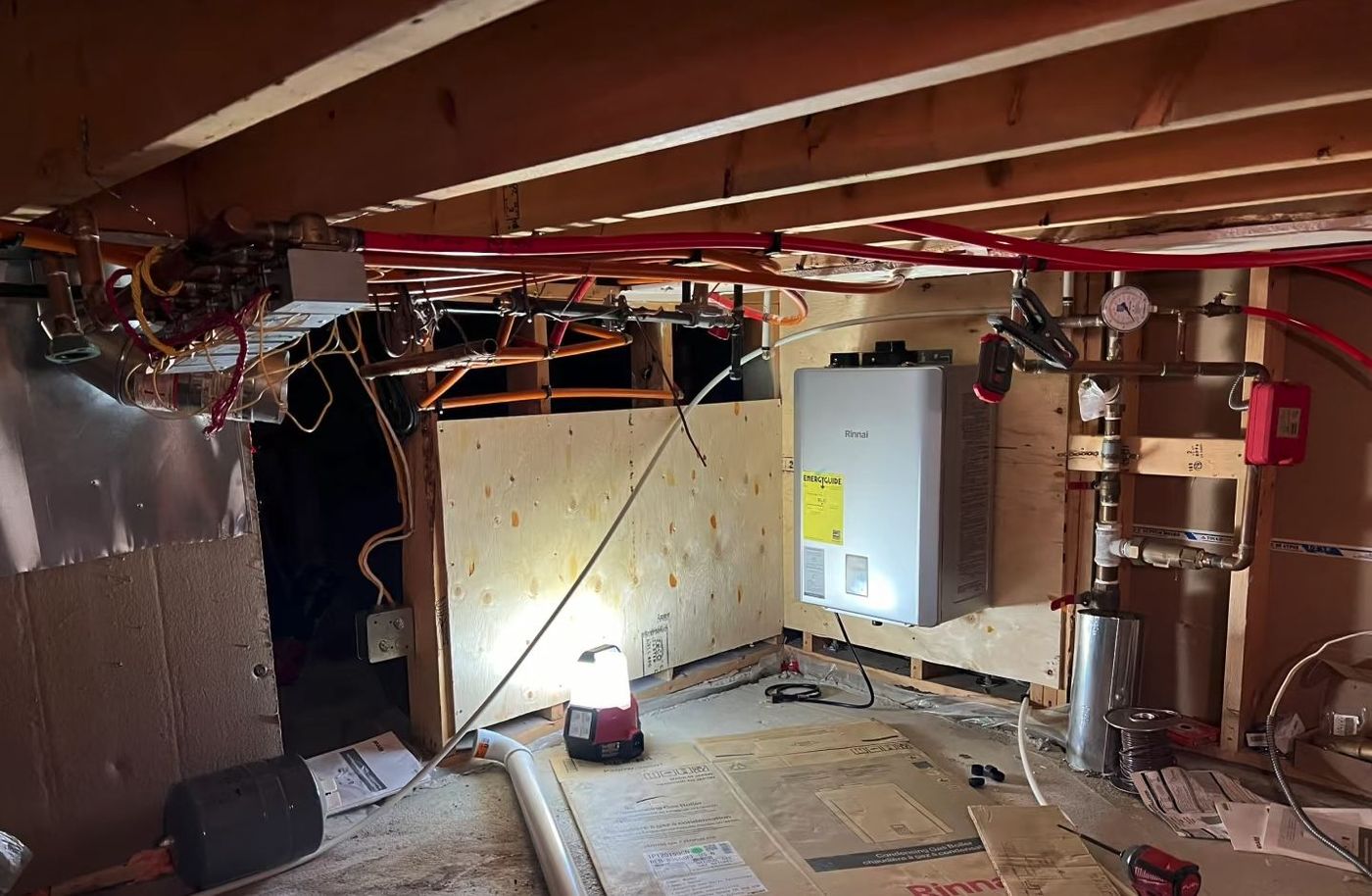 Rinnai combi boiler mounted in crawlspace with PEX radiant lines